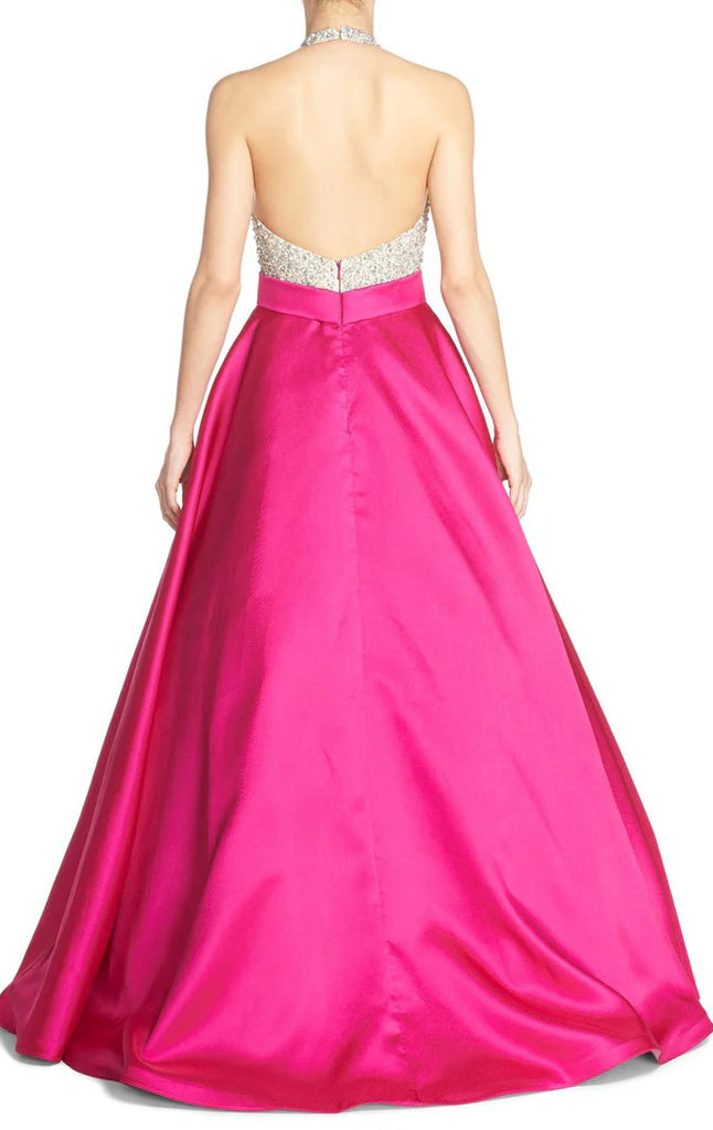 Back view of the long satin ball gown with halter neckline.