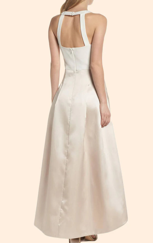 Full view of a woman wearing a flowy halter high-low satin formal gown.