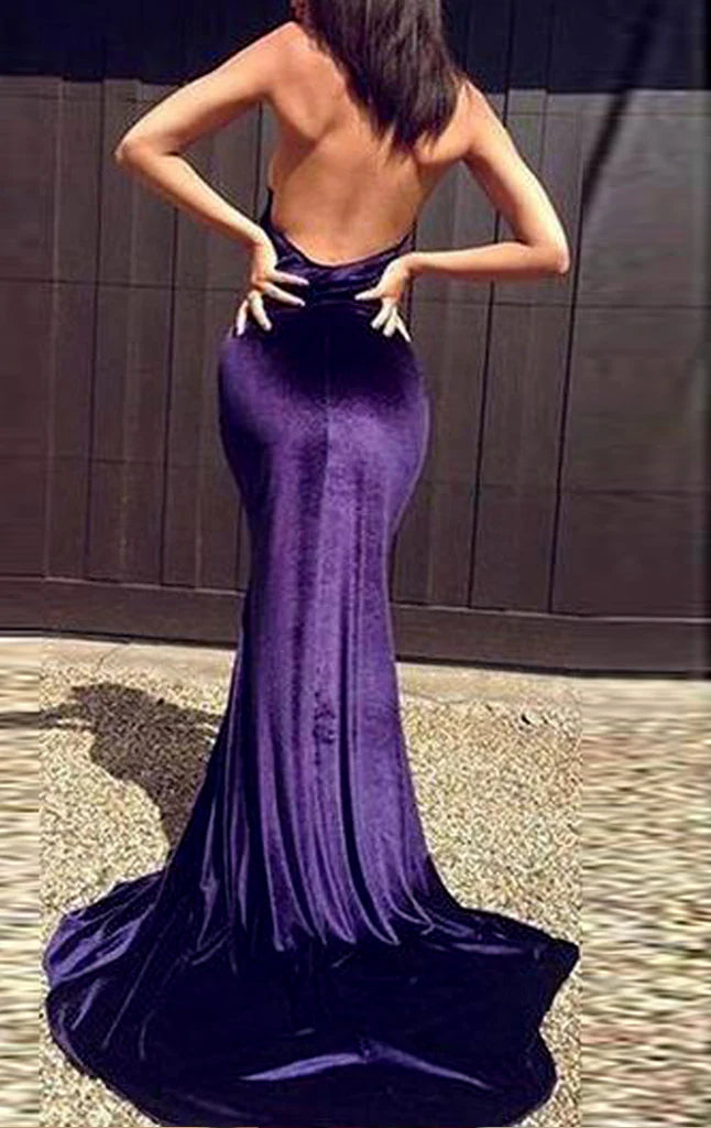 Elegant dark velvet mermaid gown with a high neck and flowing skirt.