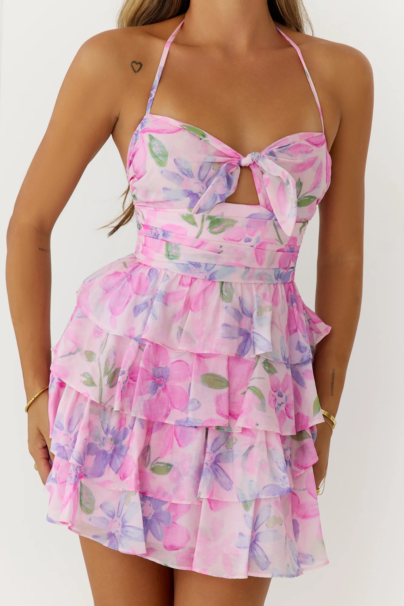 Model posing in the elegant pink floral print mini dress.