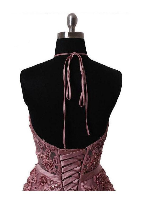 Side profile of a sleeveless lace applique maxi gown.