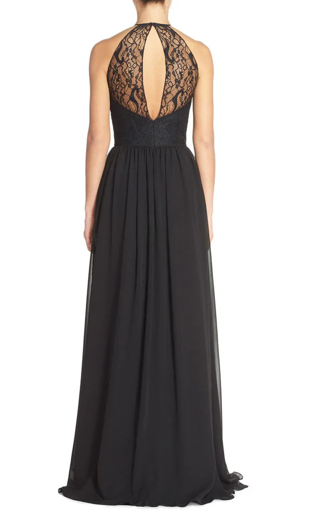 Back view of a woman in a flowing halter chiffon prom dress.