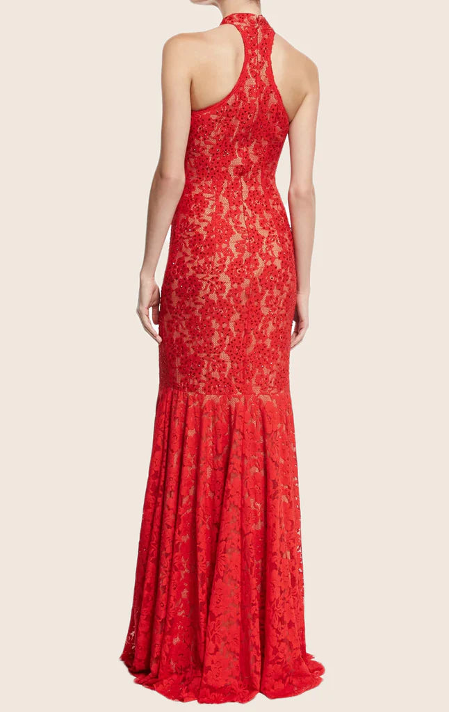 Woman modeling a mermaid halter lace evening gown.