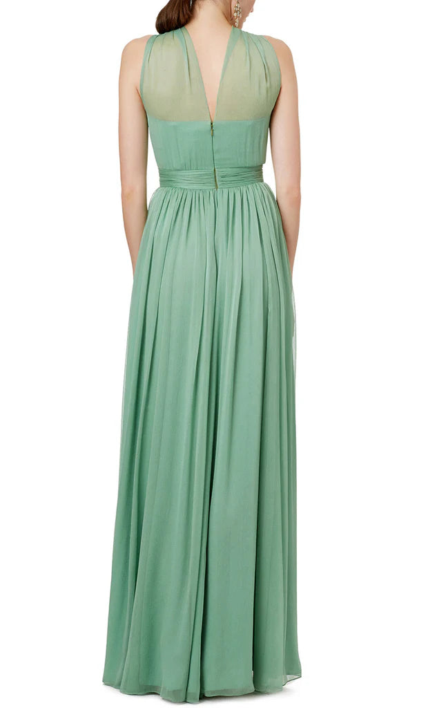 Back view of a woman in a flowing halter neck chiffon formal gown.