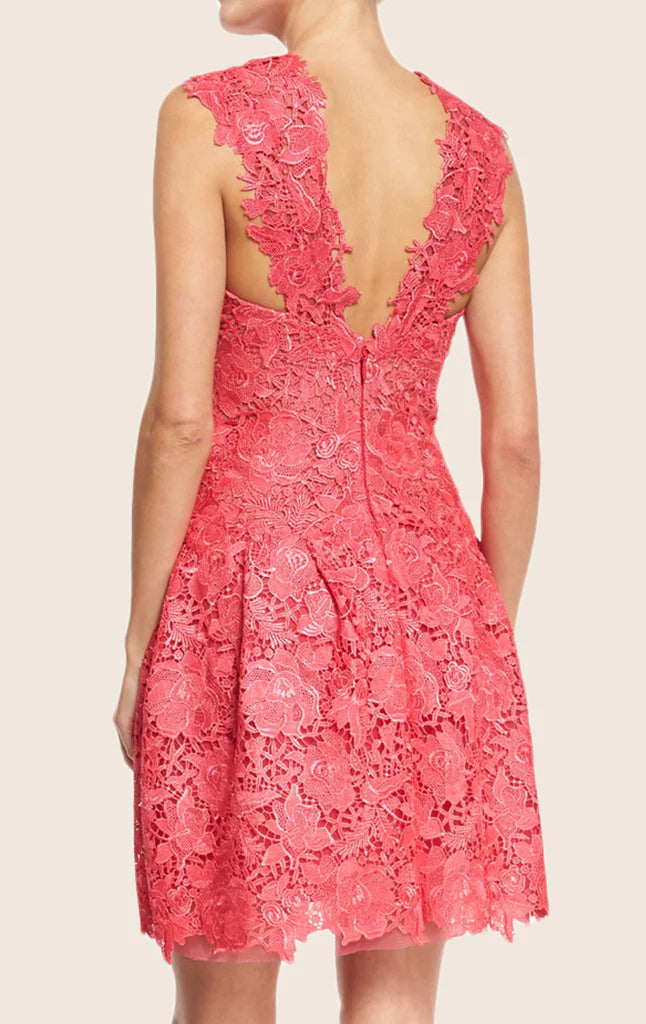 Back view of a woman in a sophisticated lace cocktail gown.