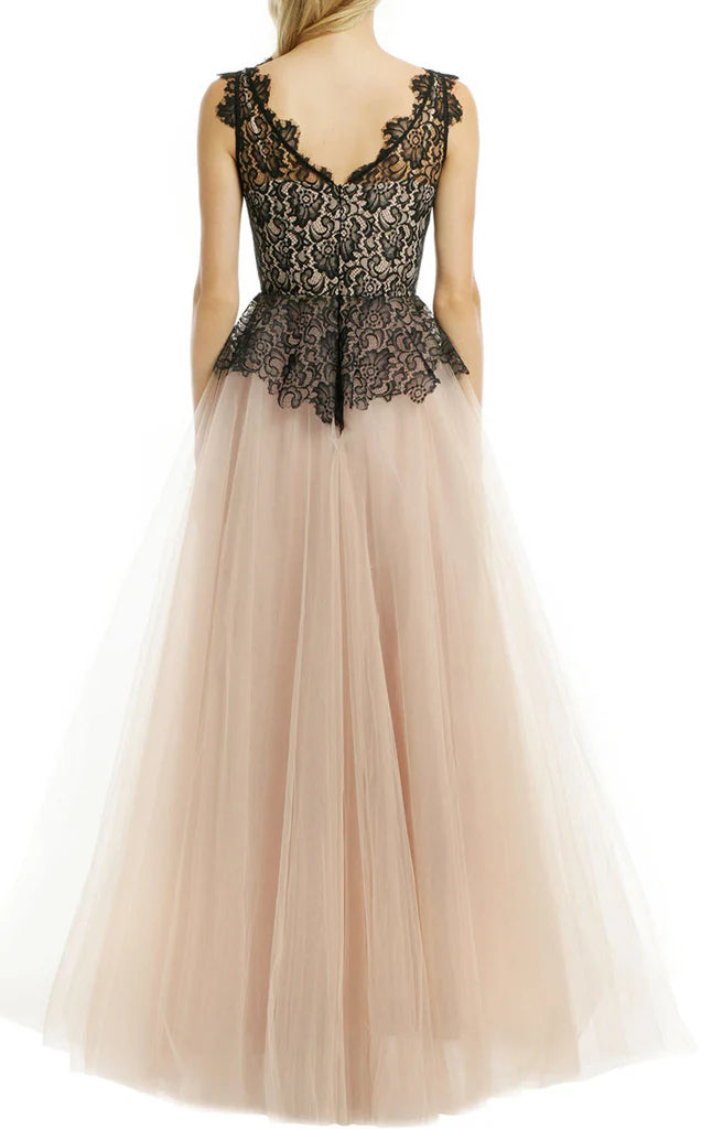 Back view of a woman in a flowing halter neck lace tulle ball gown.