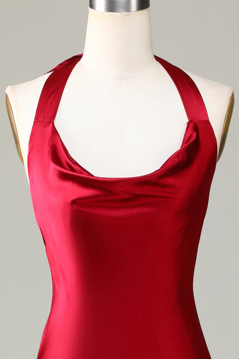 Close-up of the halter neckline and fabric detail of the elegant dress.