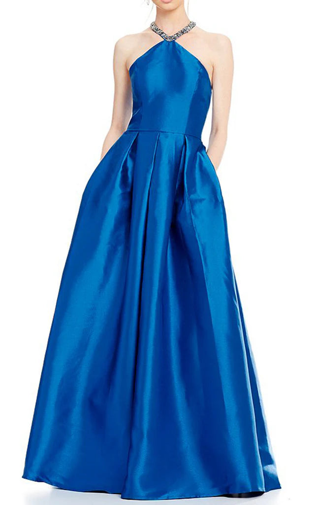 Front view of an elegant navy blue halter neck satin long prom ball gown with crystal details.
