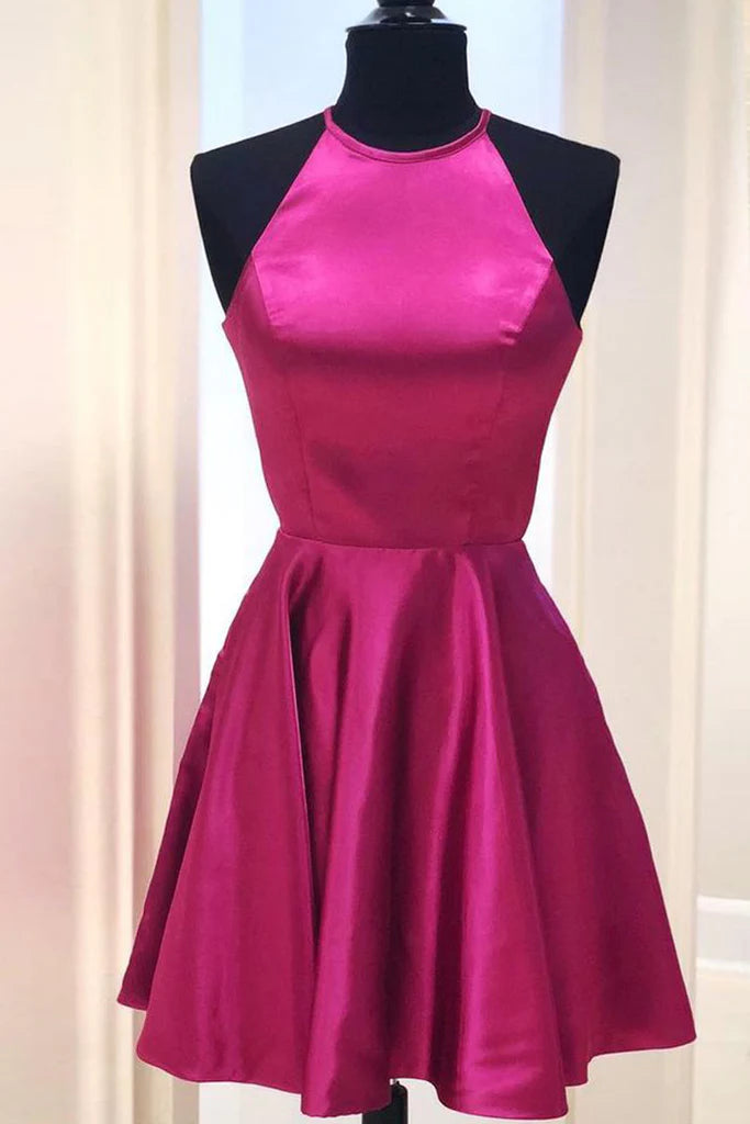 Model in a red halter neck satin mini dress, full length view.