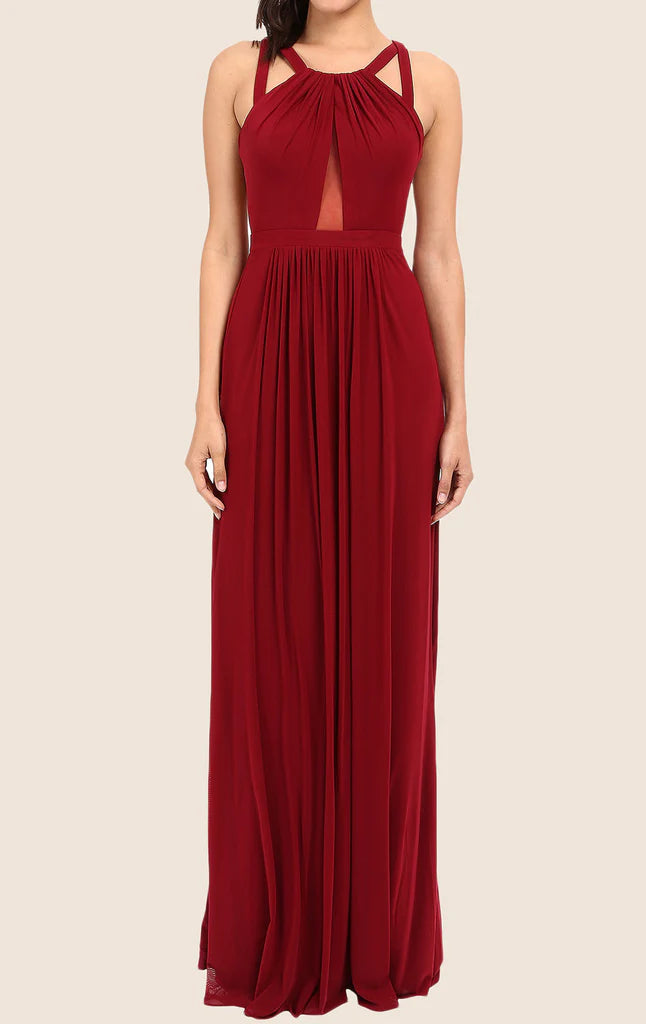 Woman wearing an elegant long halter chiffon prom dress with an open back.
