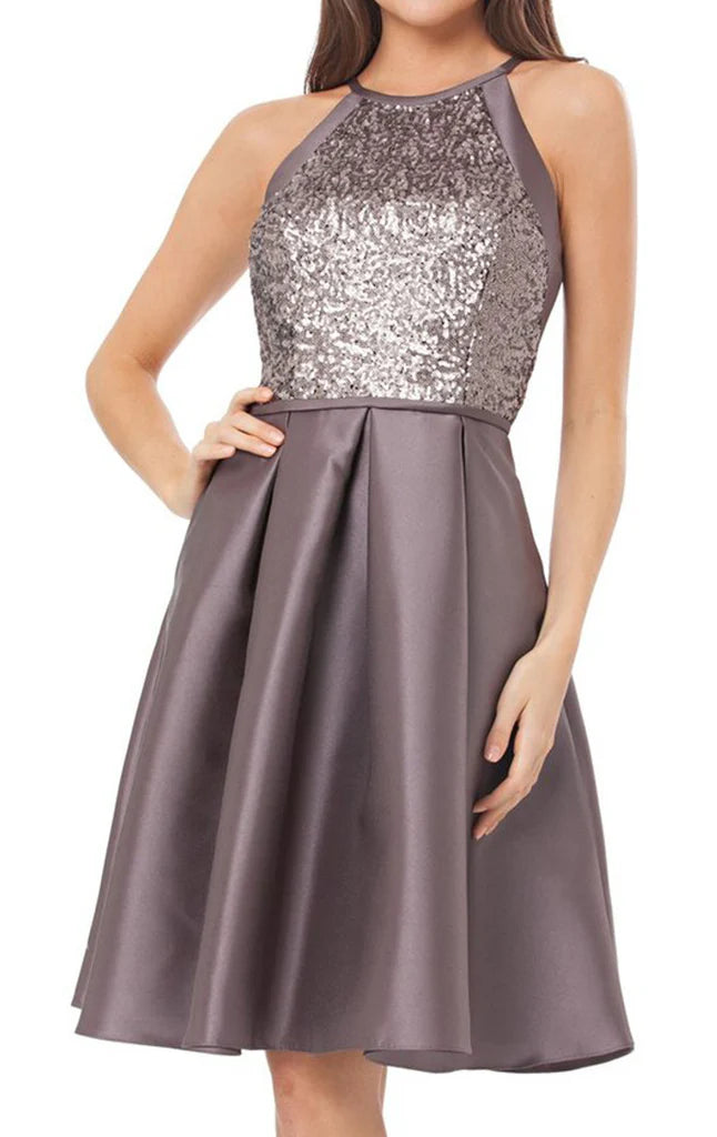 Woman wearing a dazzling halter sequin satin knee-length cocktail dress.