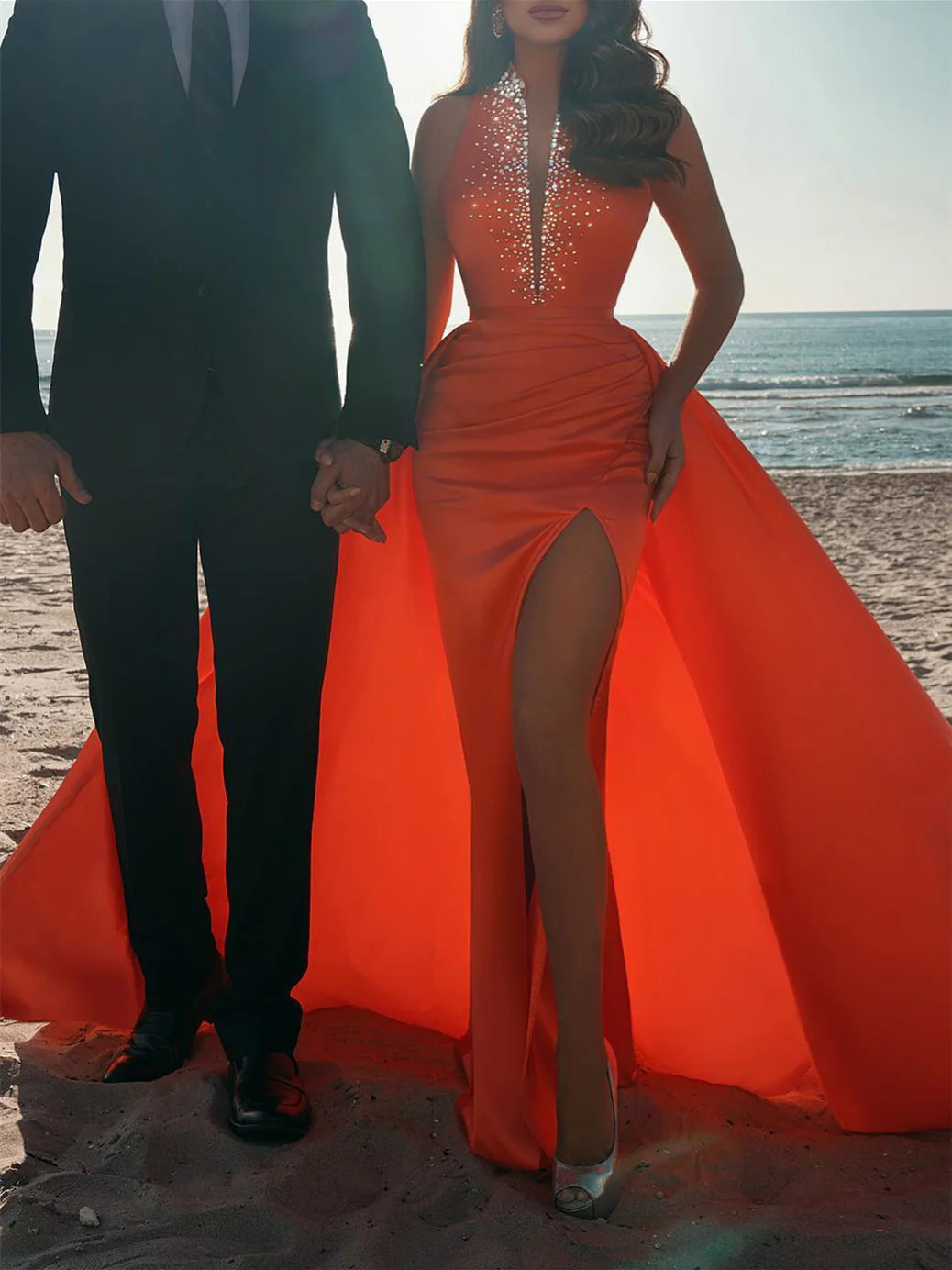 Full length view of a woman in an elegant sheath prom dress.