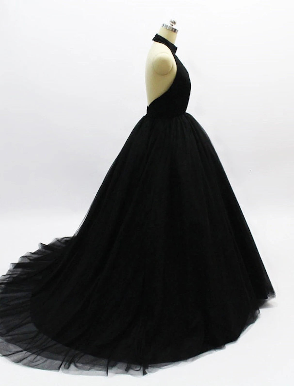 Side view of the pleated tulle ball gown, highlighting the voluminous skirt.