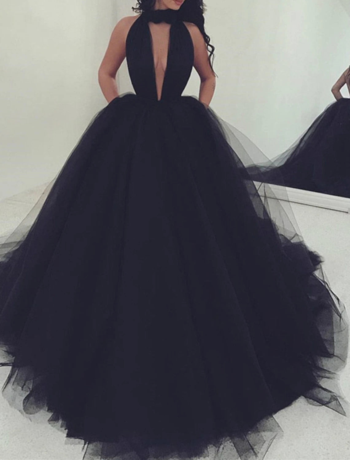 Close-up of the halter neckline and pleated details on the tulle fabric.