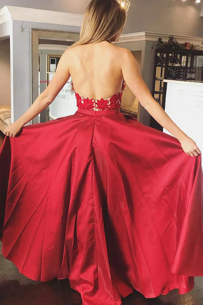 Halter V-neck lace satin gown with flowing skirt.