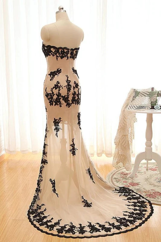 Back view of the high-low lace prom dress showing flowing hem.