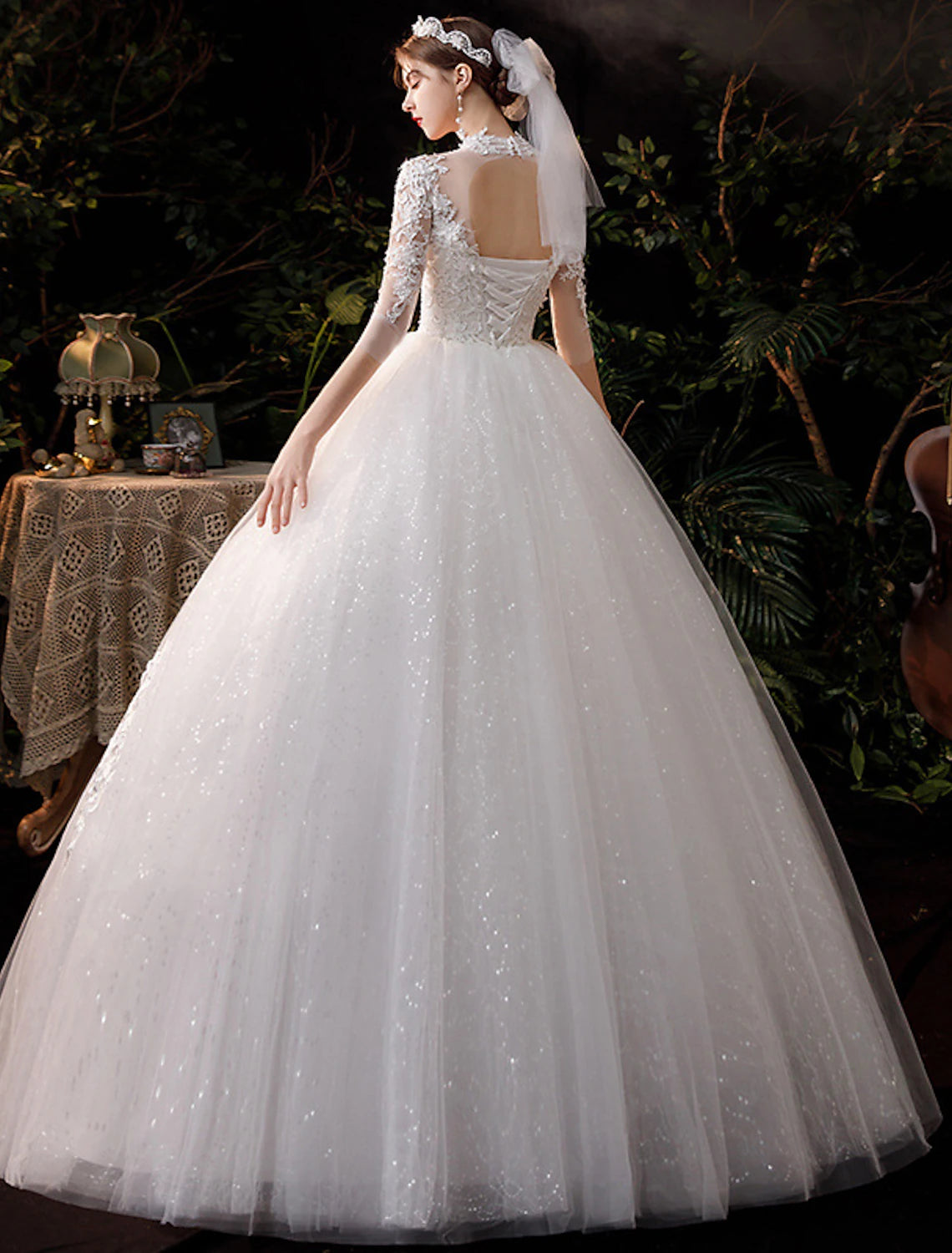 Back view of high neck half sleeve lace ball gown wedding dress.