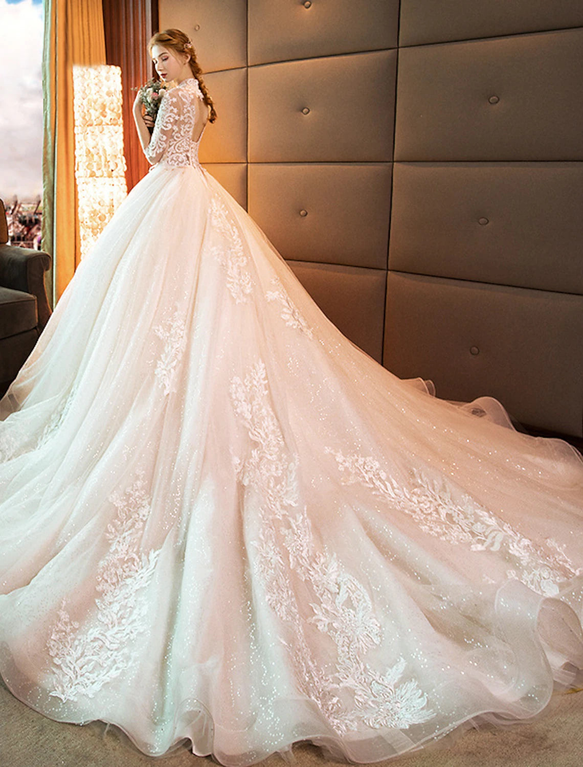 Full length view of a formal ball gown wedding dress with a high neckline.