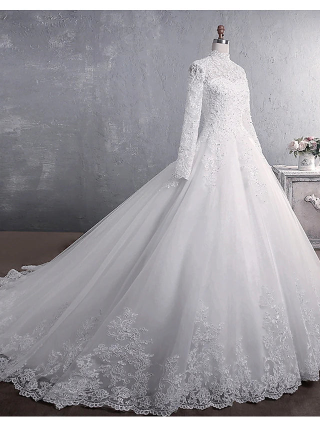 Side view of the wedding dress showing the court train and long sleeves.