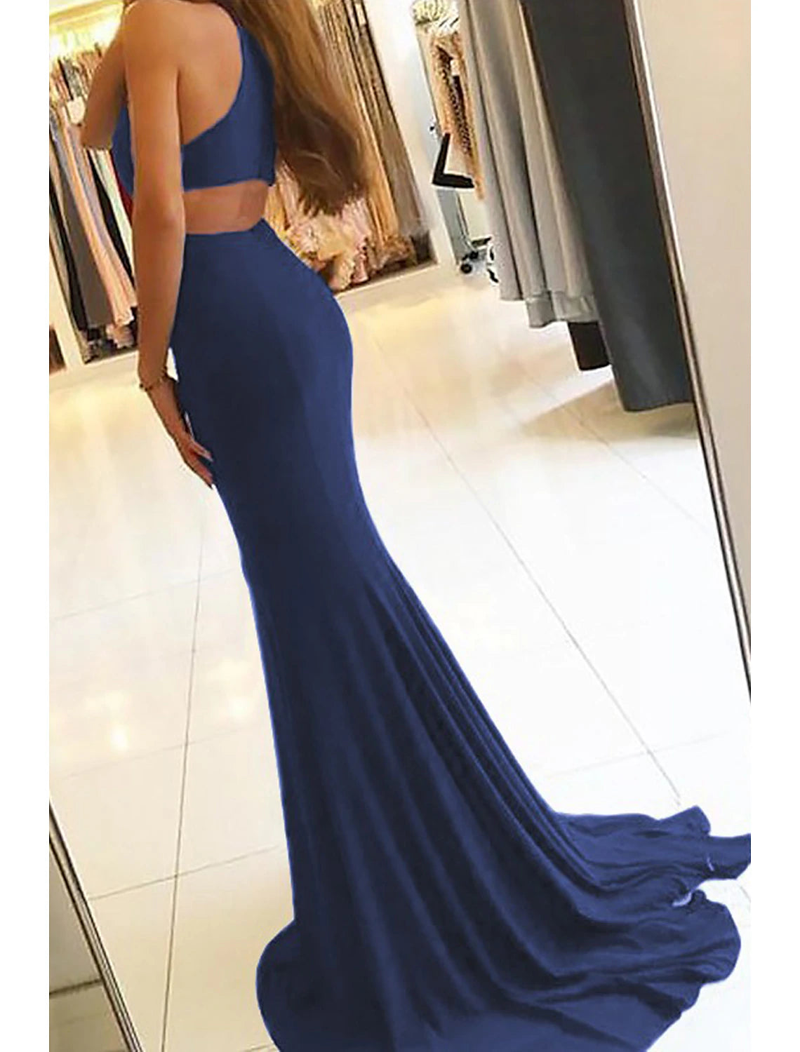 Back view of a mermaid evening gown with court train.