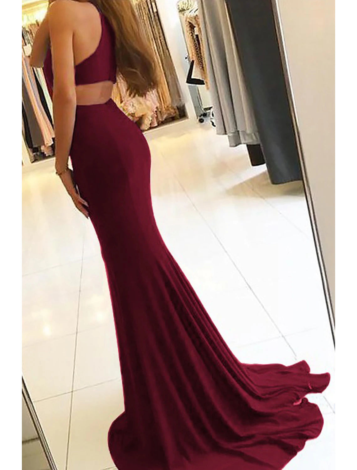 Side view of a high neck formal dress with a leg slit.
