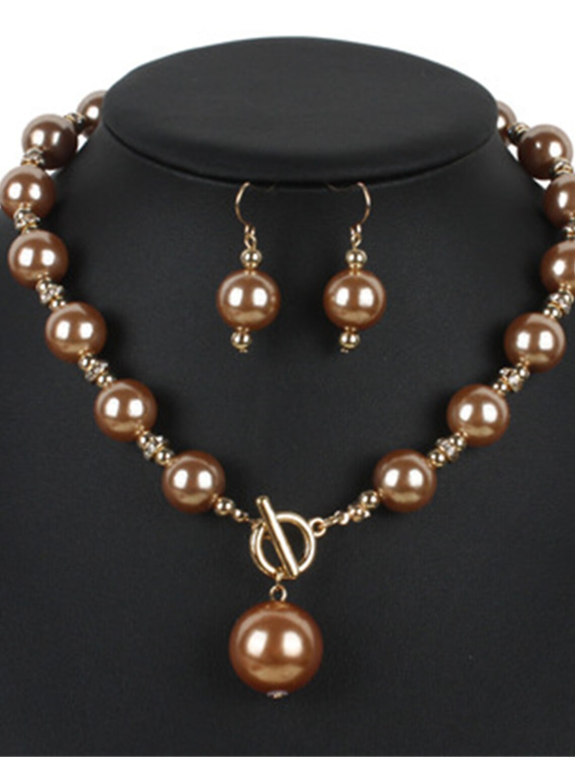 Woman wearing an elegant imitation pearl bridal necklace and matching earrings.