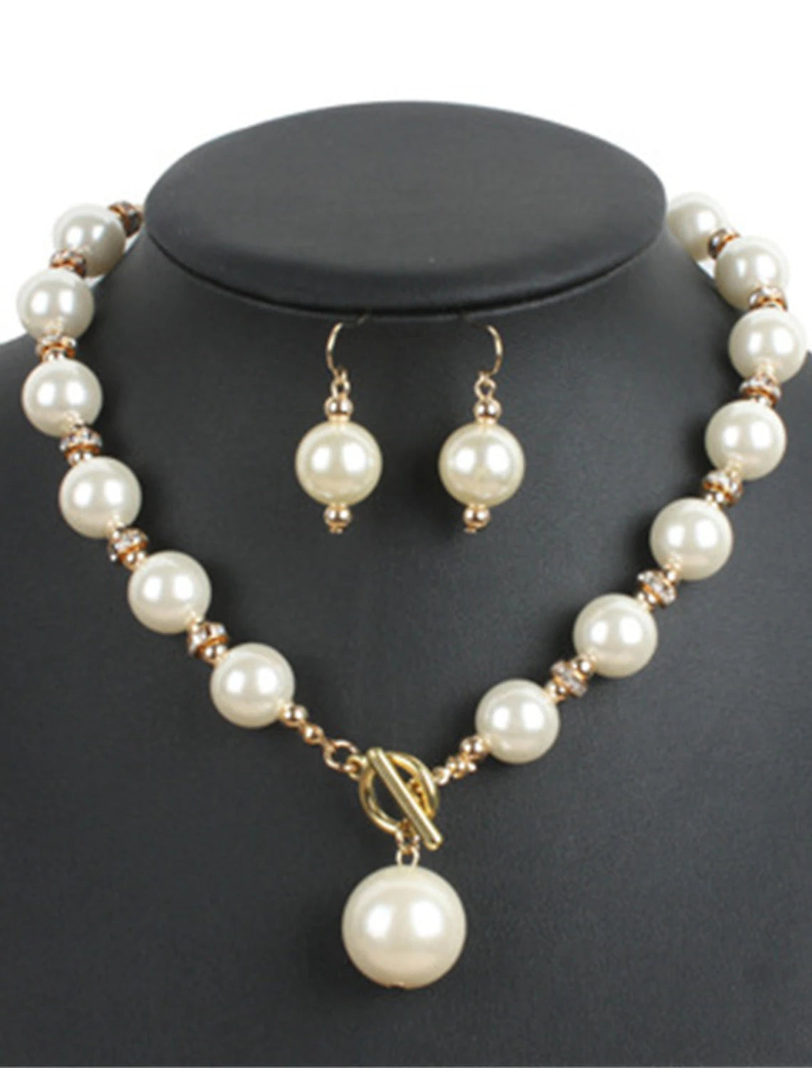 Detailed view of the imitation pearl drop earrings.