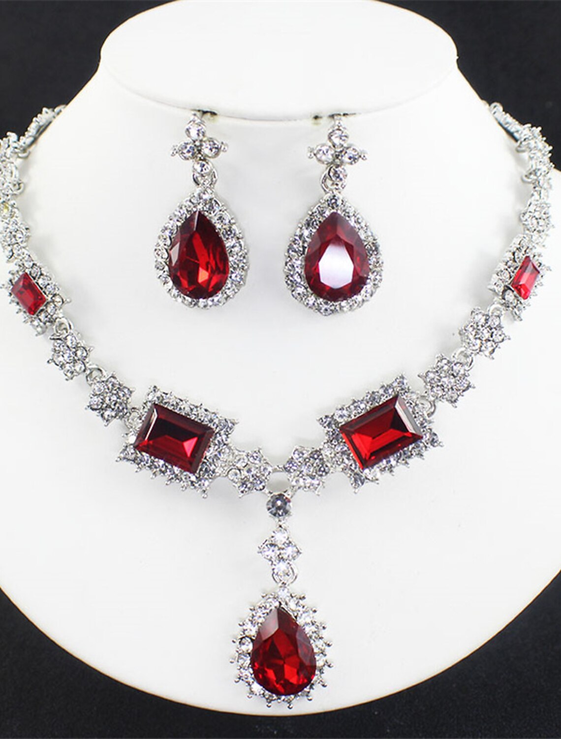 Close-up of imitation pearl necklace with transparent flower details.