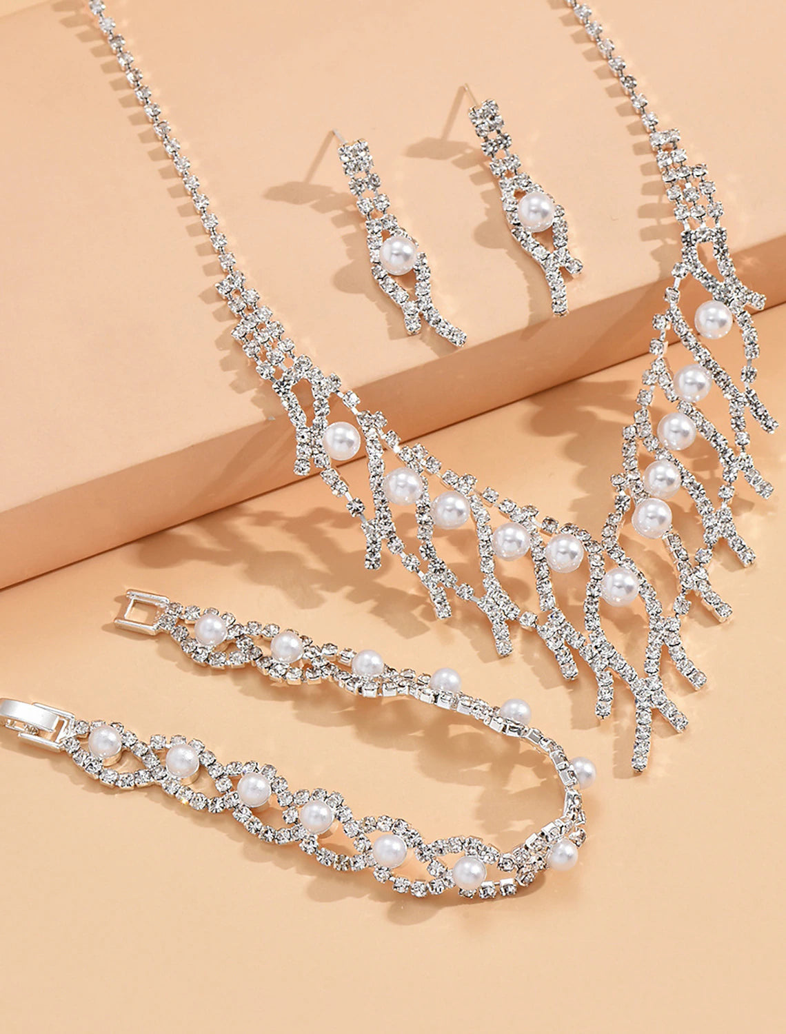 Close-up of the imitation pearl necklace with delicate tassel fringe.
