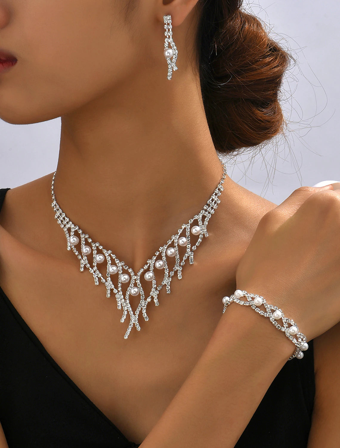 Full view of a woman wearing the imitation pearl bridal jewelry set.