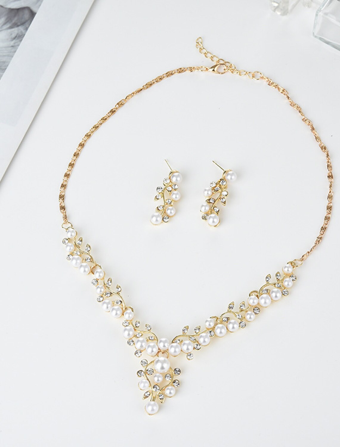Close-up of imitation pearl hoop earrings.