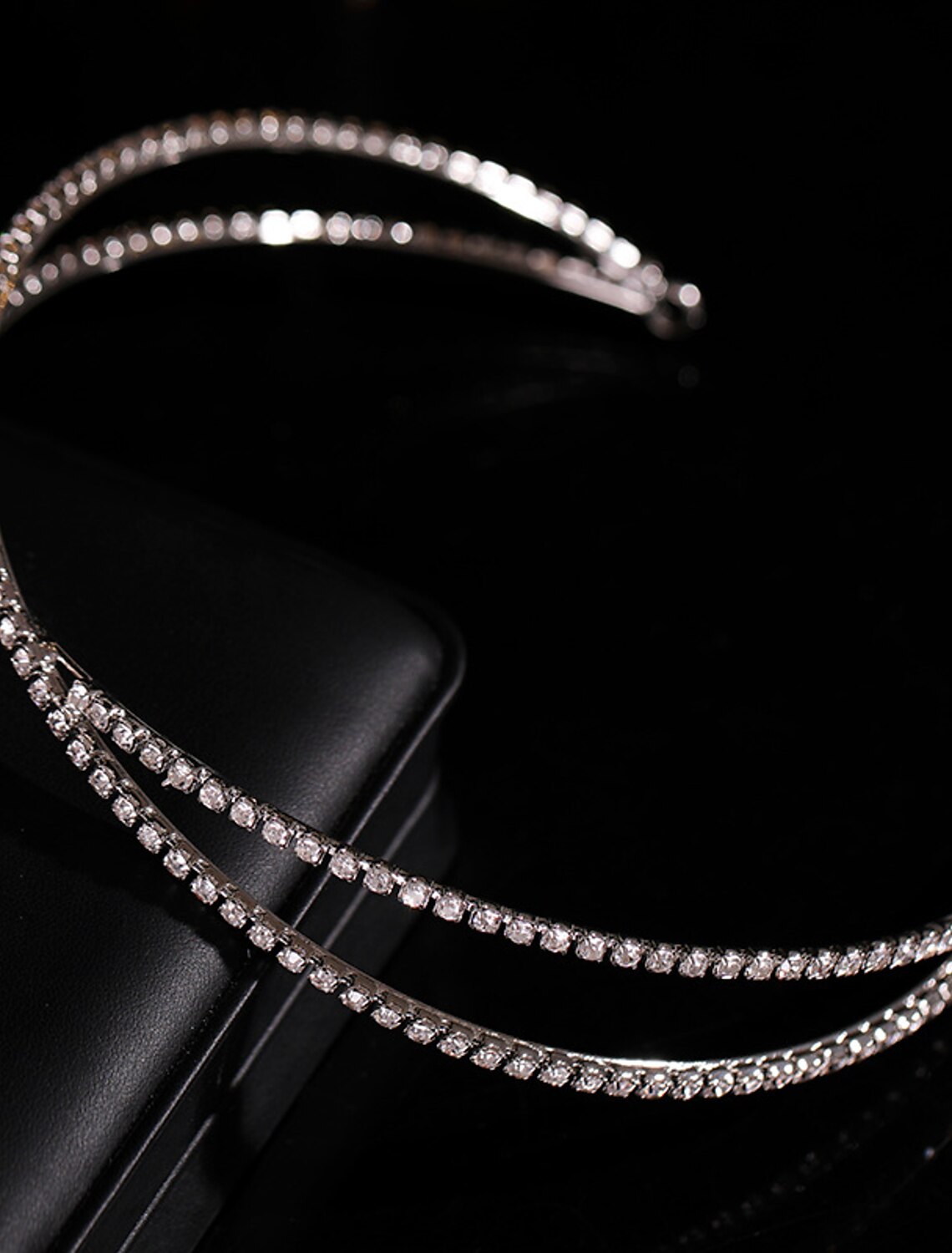 Front view of a delicate pearl and rhinestone crown.