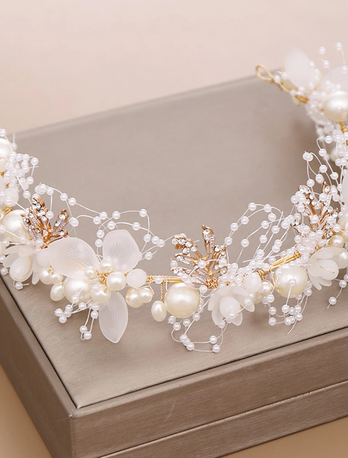 Close-up of pearl and rhinestone details on a bridal headpiece.