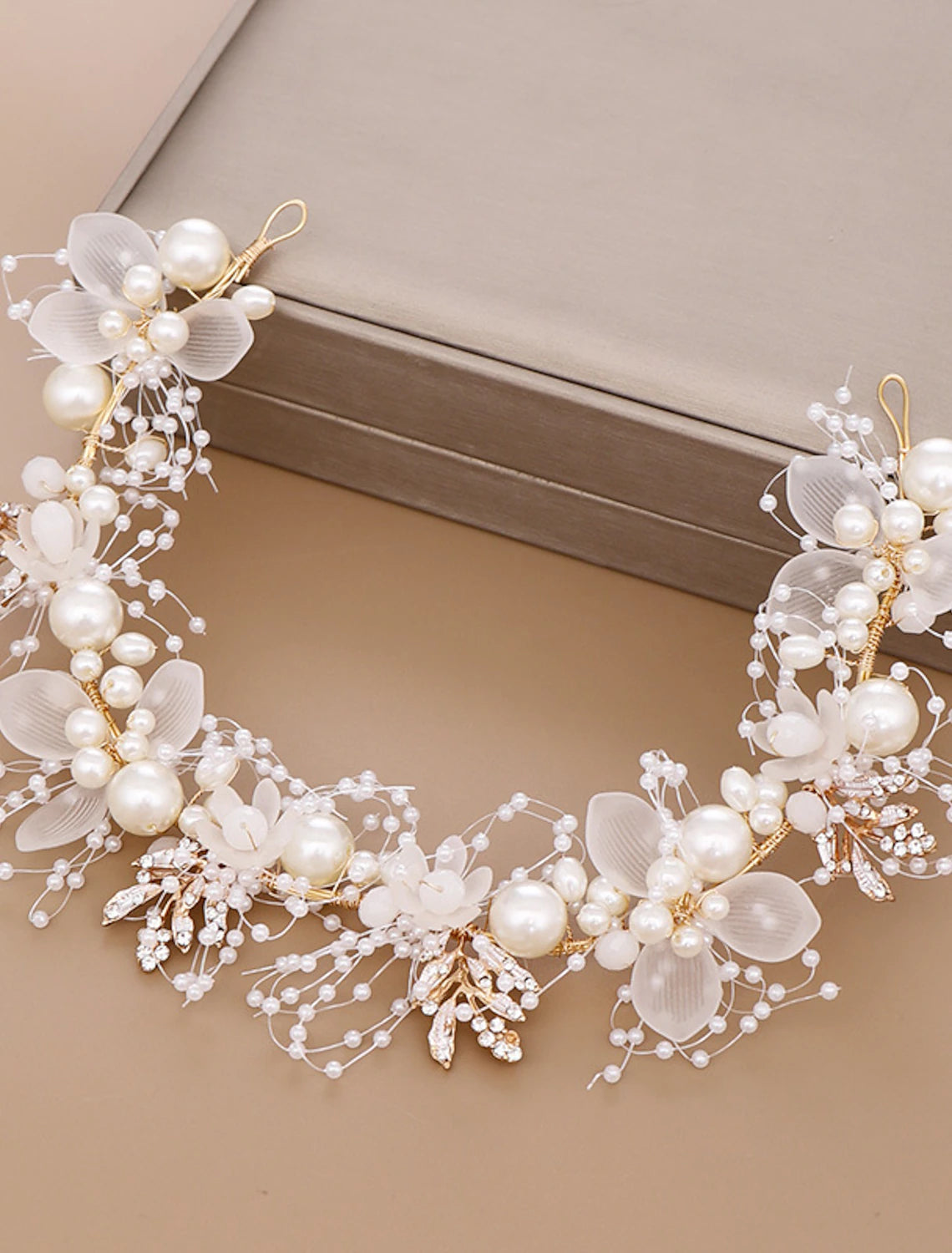 Side view of a sparkling rhinestone and pearl tiara.