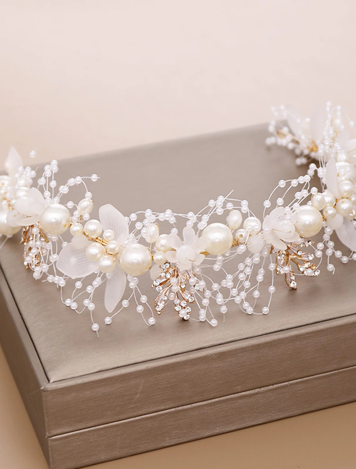 Headpiece featuring imitation pearls and clear rhinestones.
