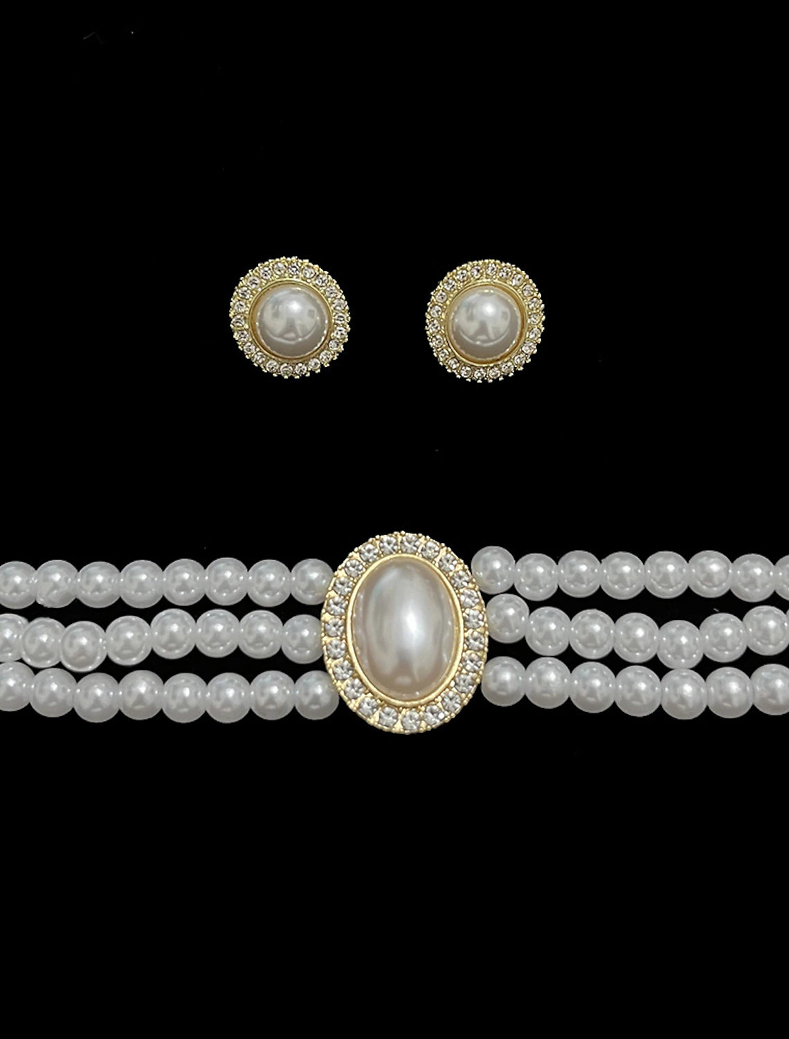 Close-up of the layered imitation pearl and rhinestone necklace.
