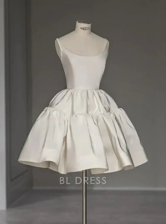 Woman wearing an elegant short ivory A-line V-neck dress.