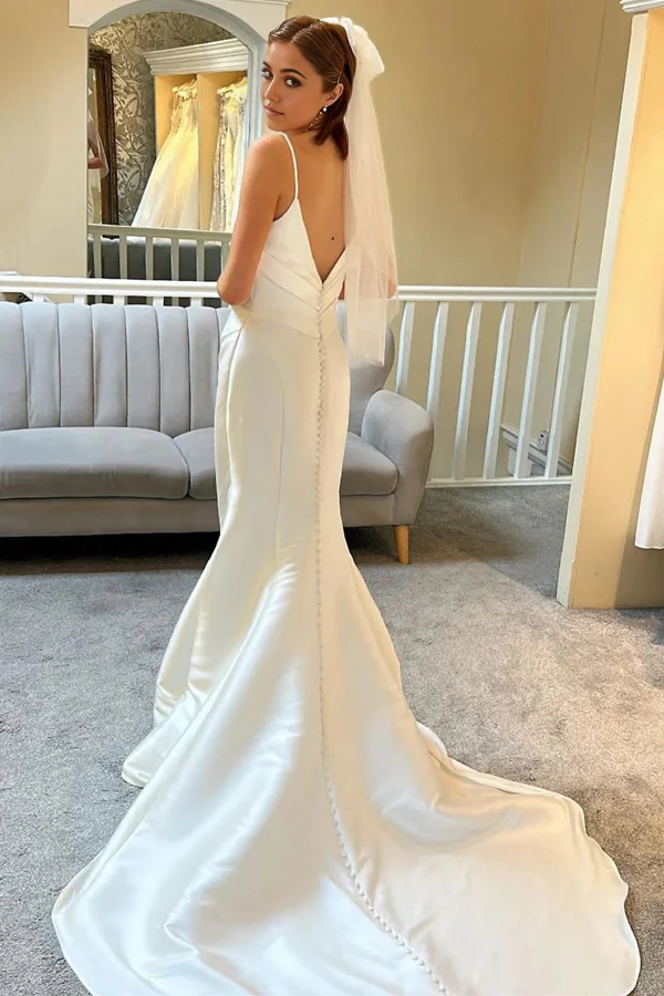 Back view of the ivory mermaid trumpet wedding dress, showcasing the backless design.