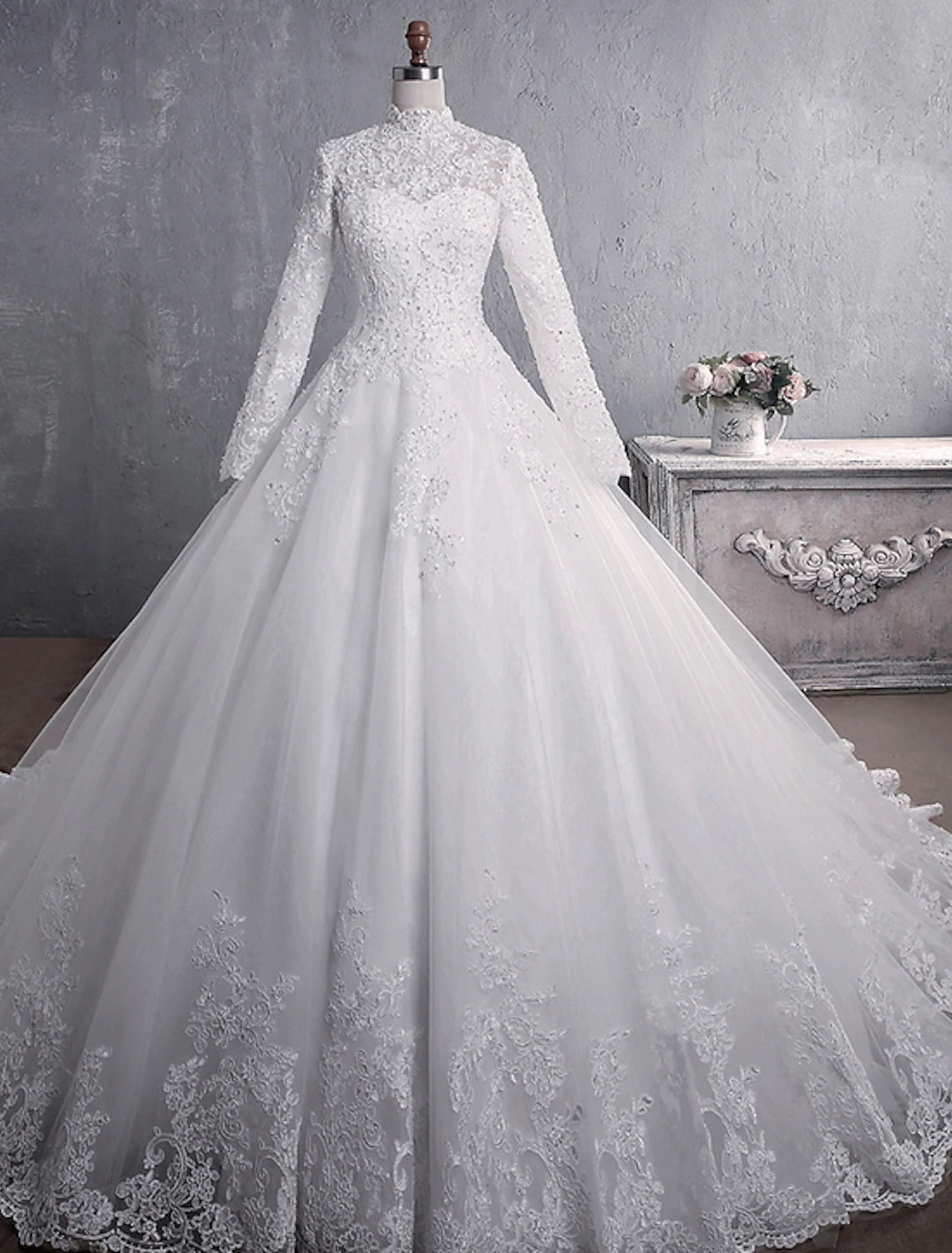 Elegant ivory ball gown wedding dress with high neck and long sleeves.