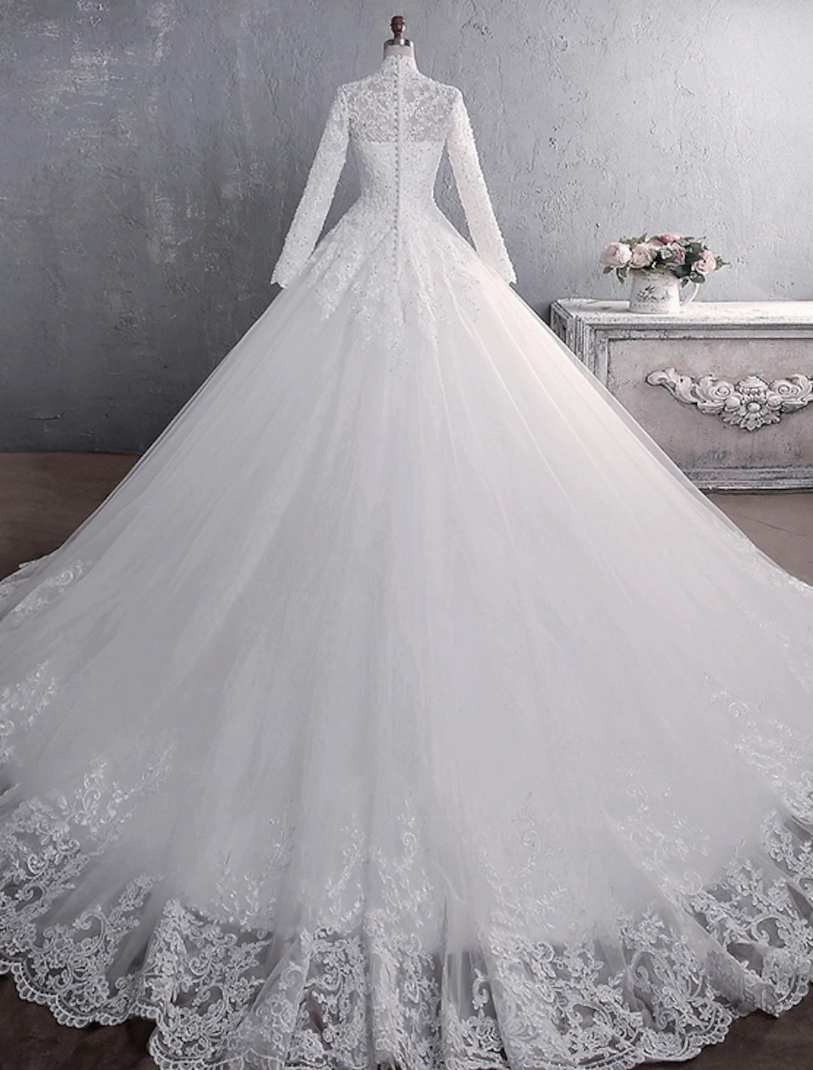 Close-up of delicate lace appliques on the bodice of the bridal gown.