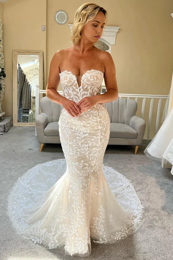 Front view of an elegant ivory lace mermaid strapless wedding gown.