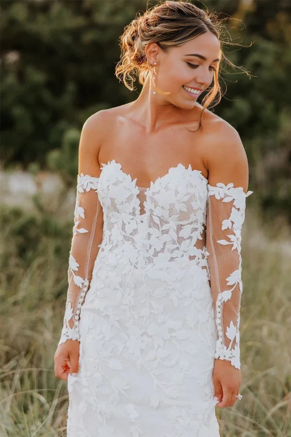 Front view of an elegant ivory mermaid trumpet wedding dress with sweetheart straps.