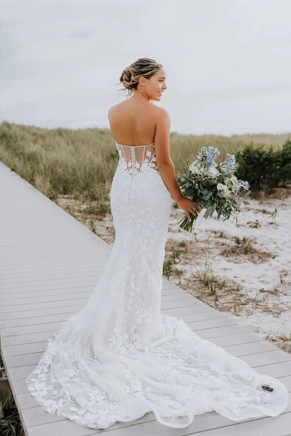 Back view of the ivory mermaid trumpet wedding dress, highlighting the backless design.