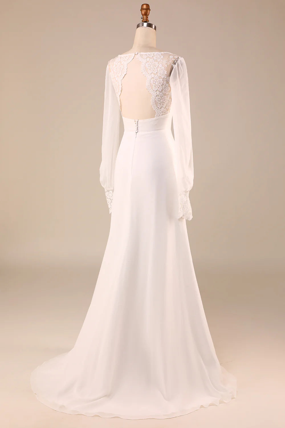 Back view of an ivory mermaid wedding dress, highlighting the open back design.