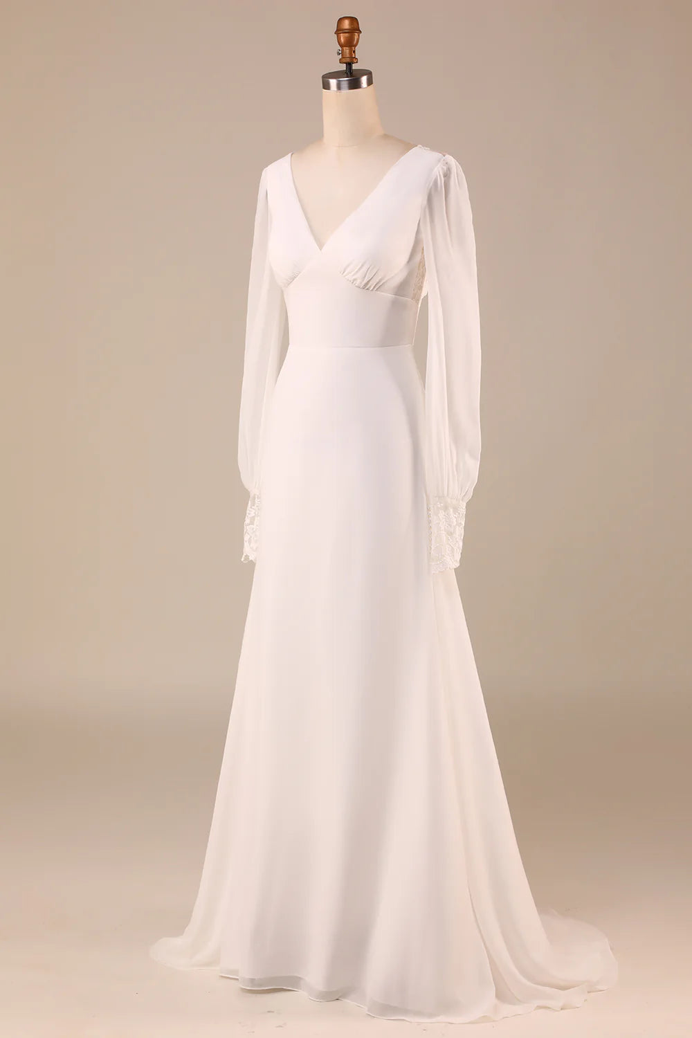 Close-up of the long sleeves and bodice details on an ivory wedding dress.