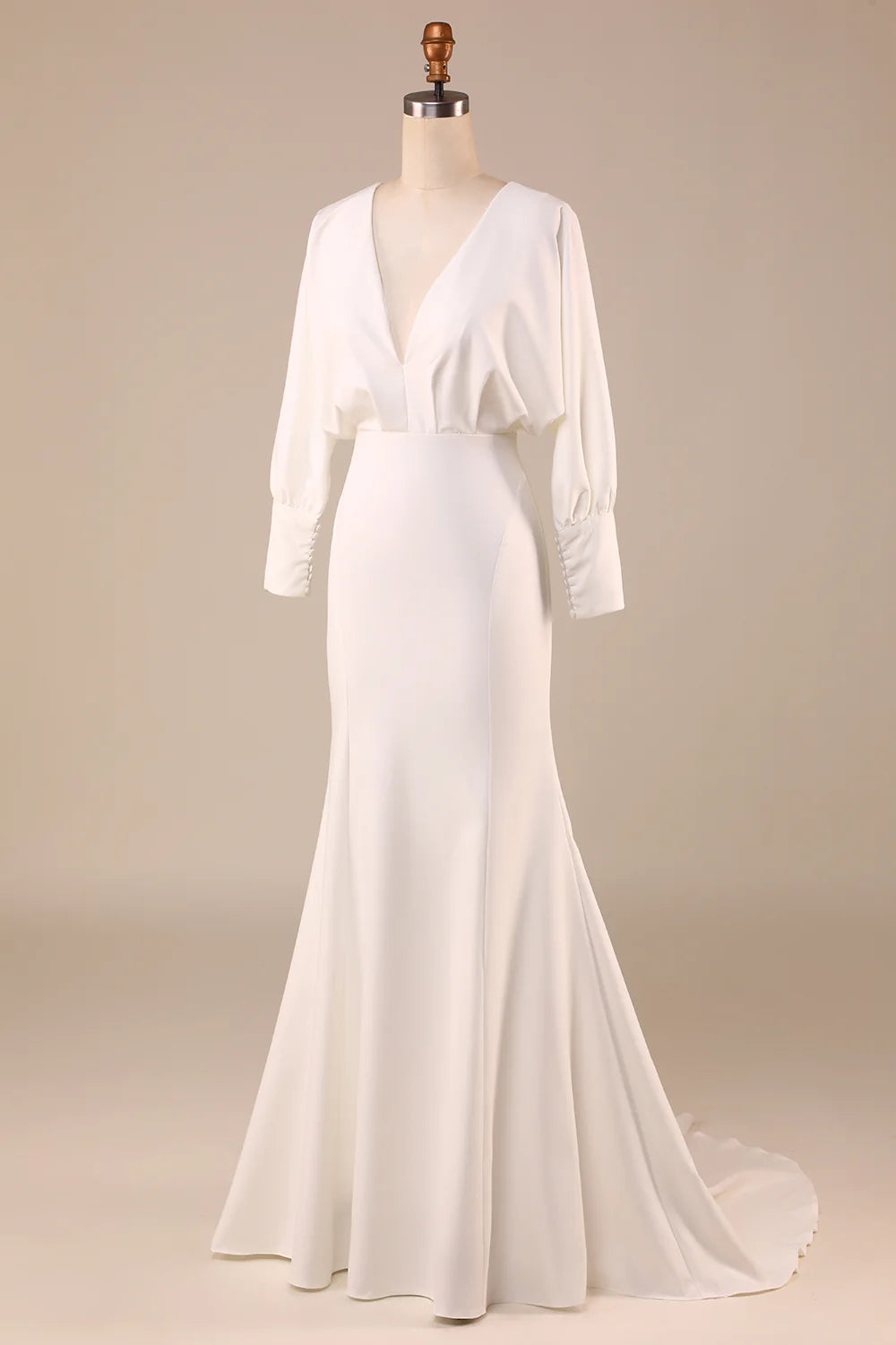 Close-up of the long sleeves and satin fabric on the wedding dress.