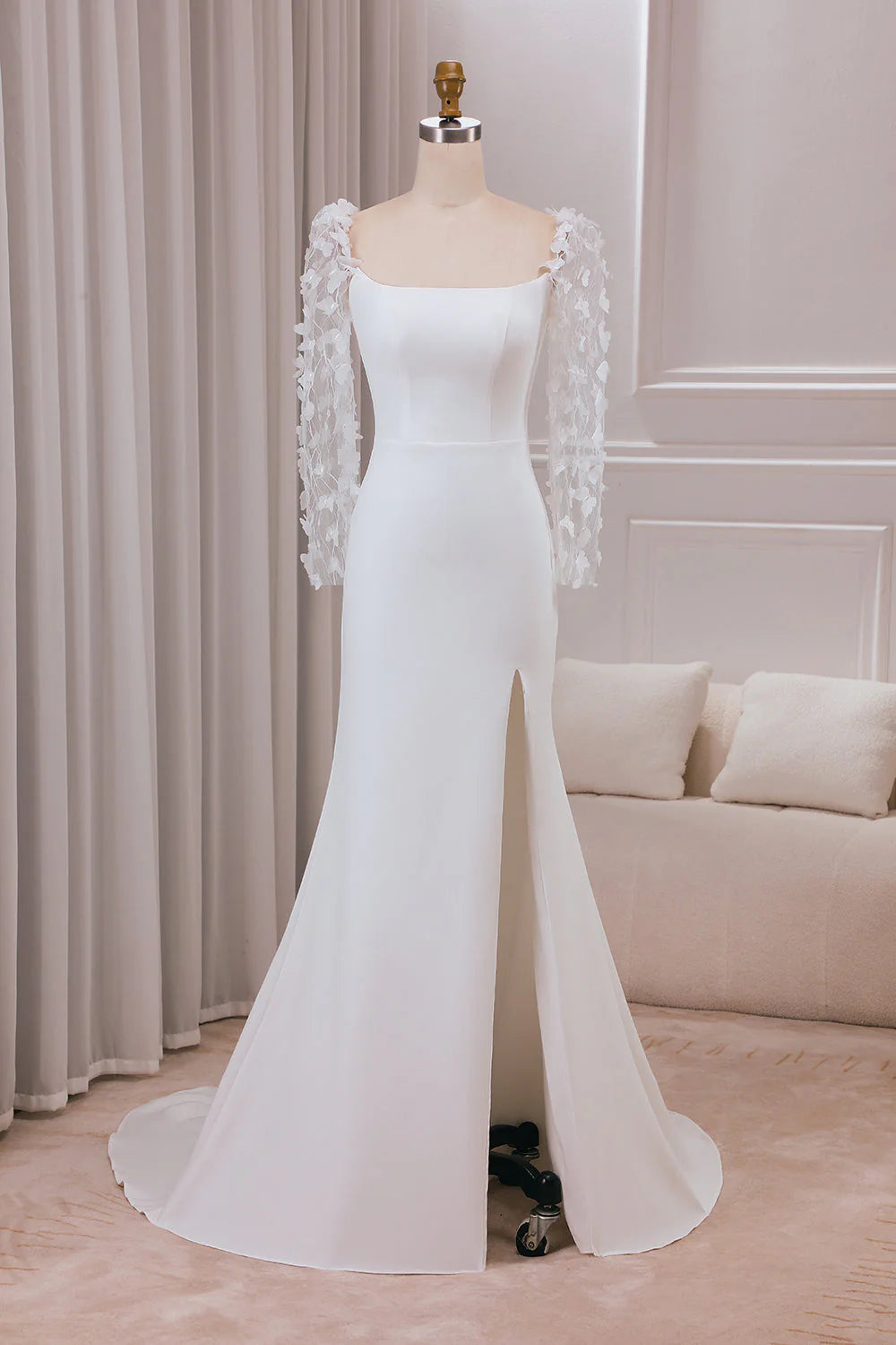 Elegant ivory trumpet wedding dress with long sleeves and 3D appliques.