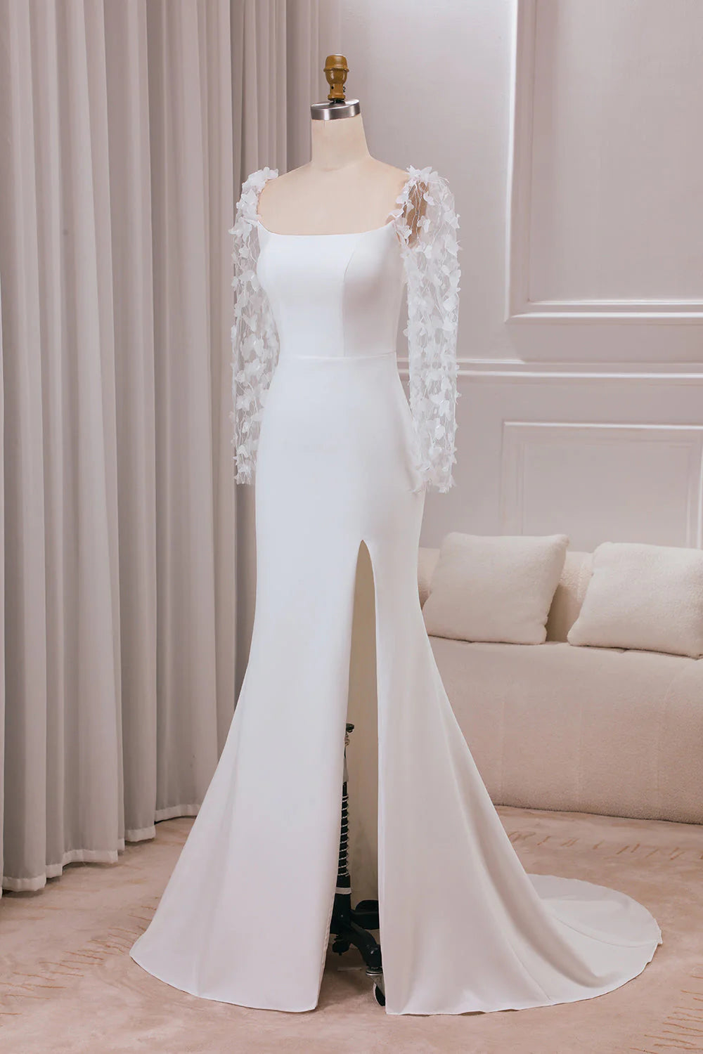 Side view of ivory trumpet wedding dress with long sleeves.