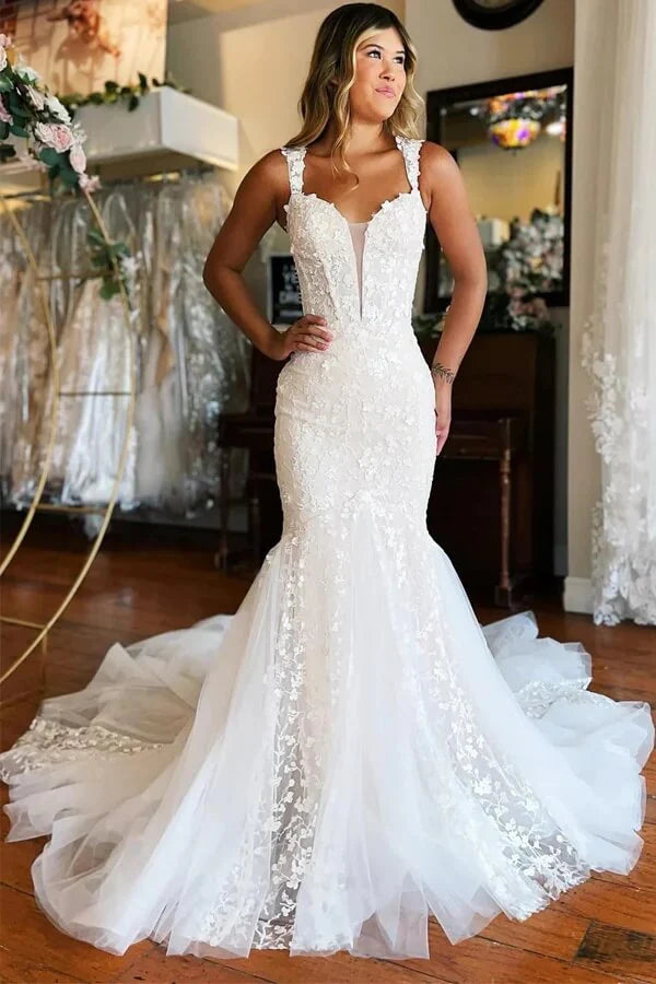 Elegant ivory mermaid wedding dress with V-neck and lace appliques.