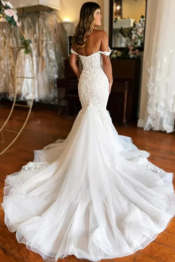 Back view of ivory mermaid wedding gown with delicate tulle skirt.